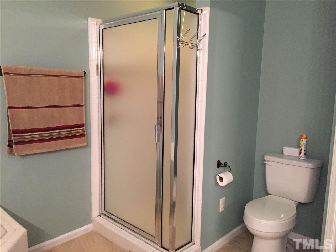 11917 Eagle Bluff Circle Raleigh, NC 27613 - Photo 17 of 25 a bathroom with a toilet and a shower