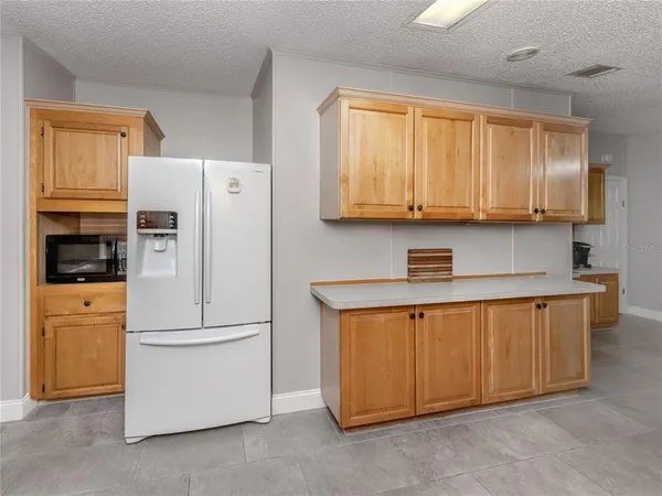 a kitchen with stainless steel appliances a refrigerator sink and cabinets