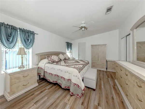 a spacious bedroom with a bed and a window