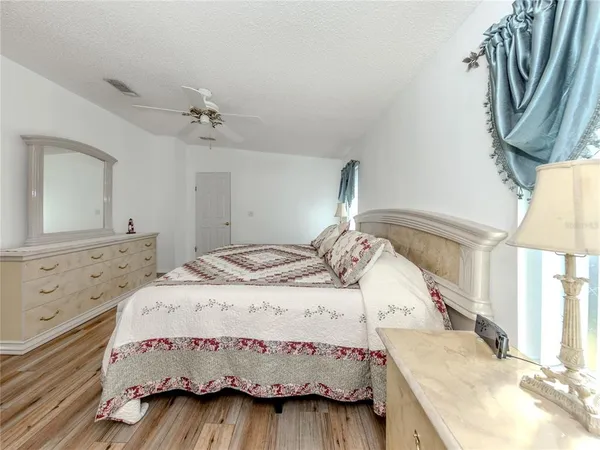 a bedroom with a bed and a mirror