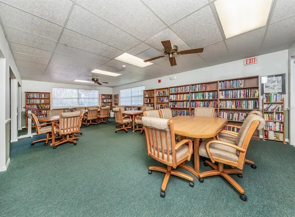 a dining room with furniture and a rug
