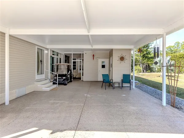 a view of living room filled with furniture and large window