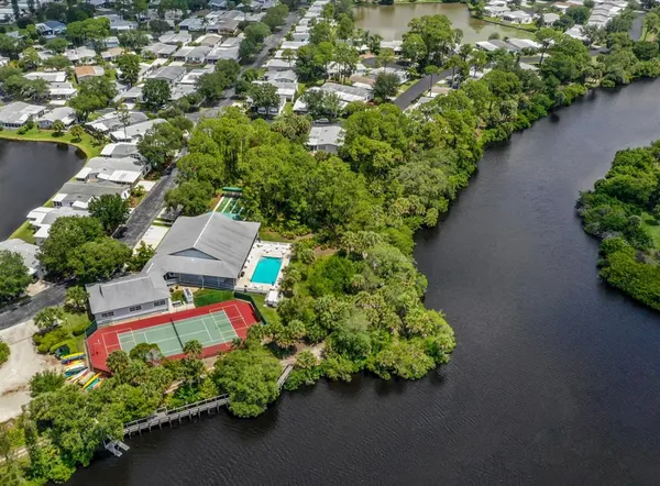 an aerial view of a house with a yard swimming pool and outdoor seating