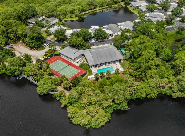 an aerial view of a house with a yard and lake view