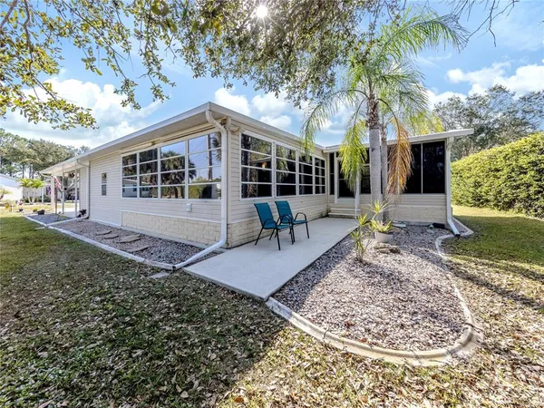 a view of a house with a yard patio and fire pit