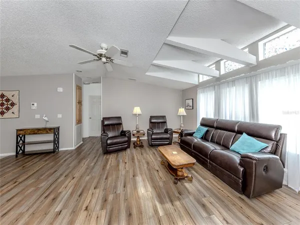 a living room with furniture and a wooden floor