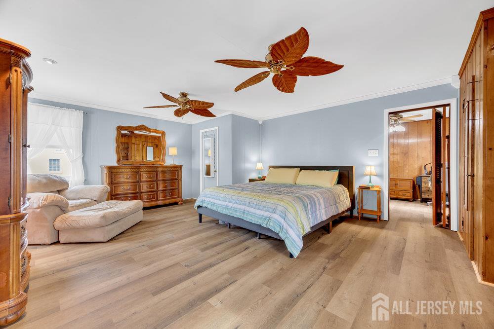 98 William Street South River, NJ 08882 - Photo 32 of 52 a bedroom with a large bed and a chandelier