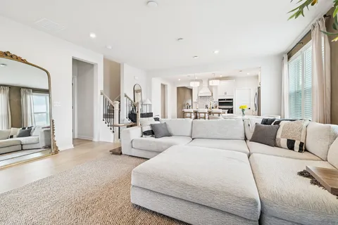 a large bedroom with a large bed couch and a large window