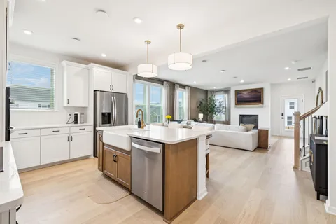 a kitchen with a stove a refrigerator and a fireplace