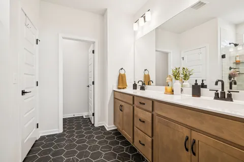 a spacious bathroom with a double vanity sink mirror and