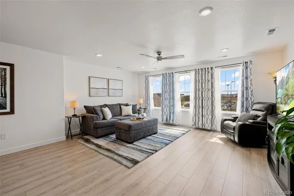 a living room with furniture and wooden floor