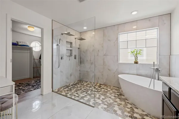 a bathroom with a bathtub and shower