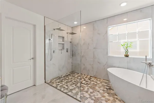 a bathroom with a bathtub and a shower