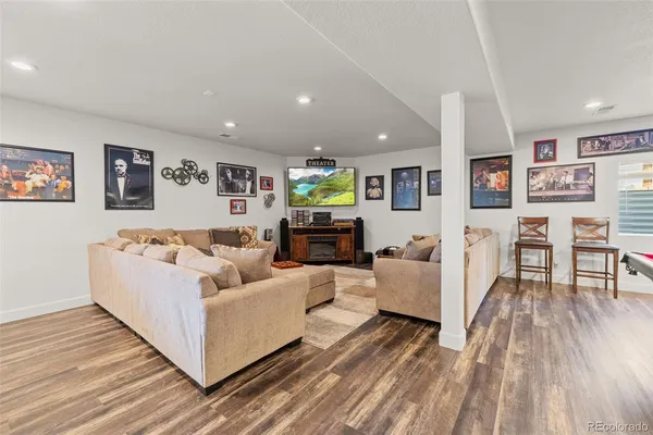 a living room with furniture and wooden floor