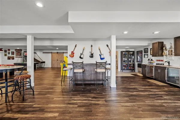 a living room with lots of furniture and kitchen view
