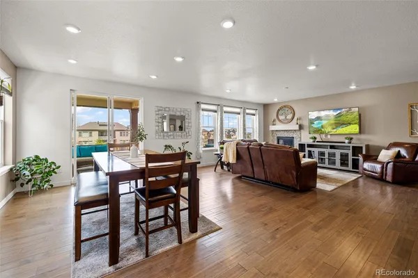a living room with furniture dining area and a wooden floor