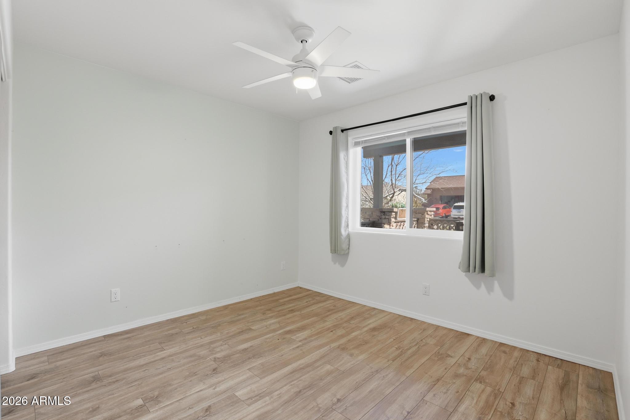202 North Durango Court Payson, AZ 85541 - Photo 18 of 27 a view of an empty room with wooden floor and a window