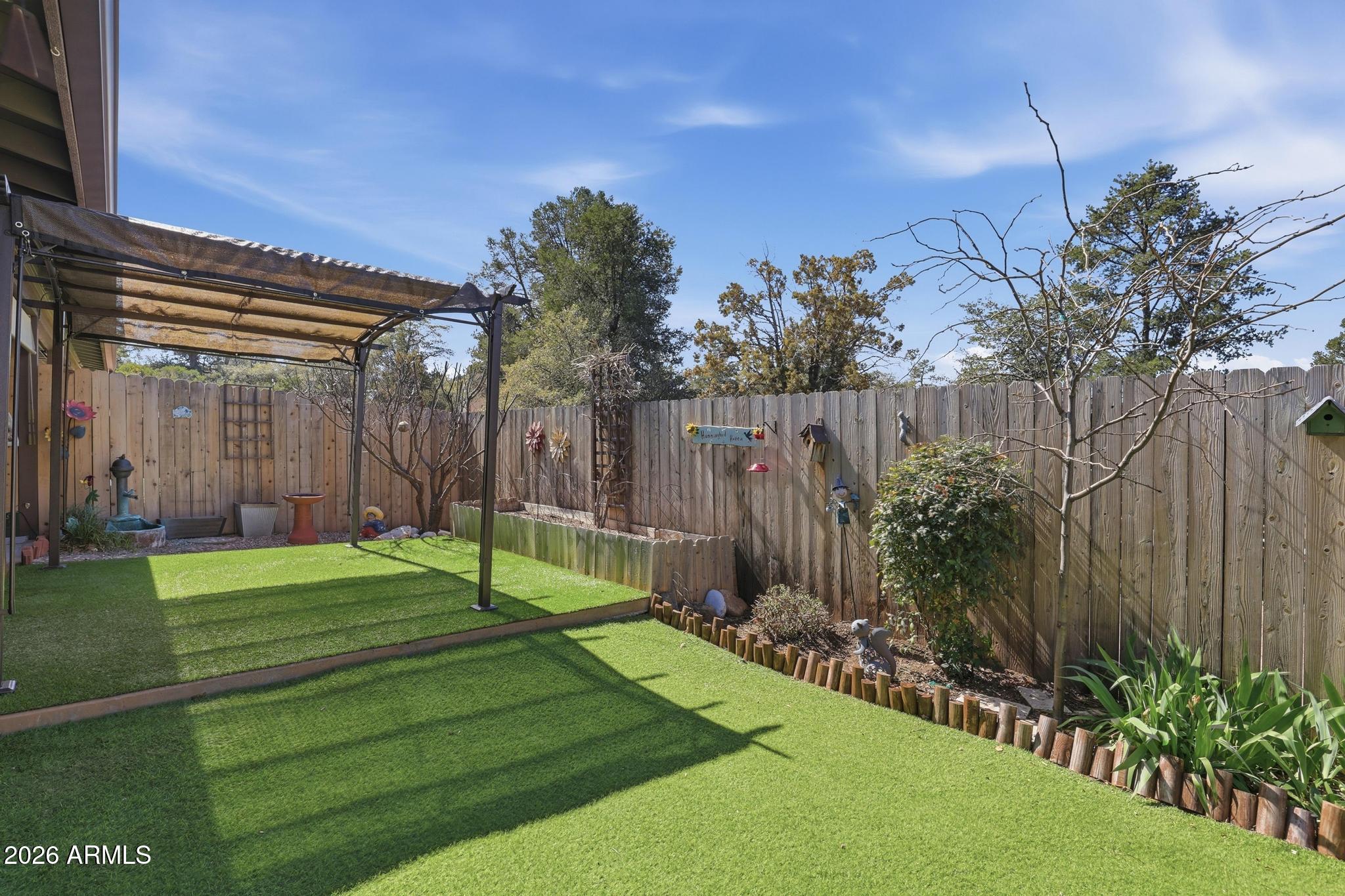 202 North Durango Court Payson, AZ 85541 - Photo 24 of 27 a view of a backyard with potted plants and large trees