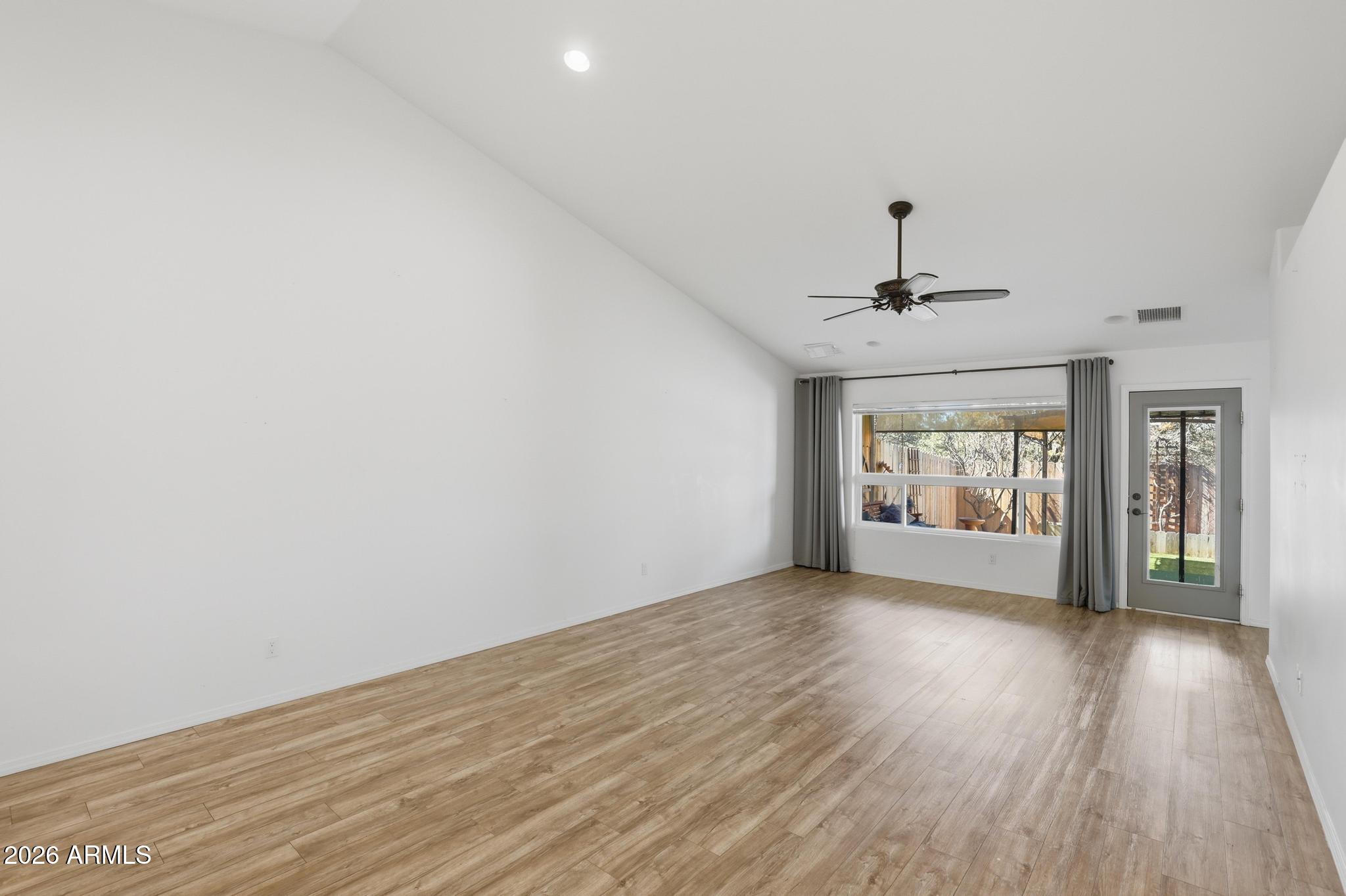 202 North Durango Court Payson, AZ 85541 - Photo 6 of 27 a view of an empty room with a window and wooden floor