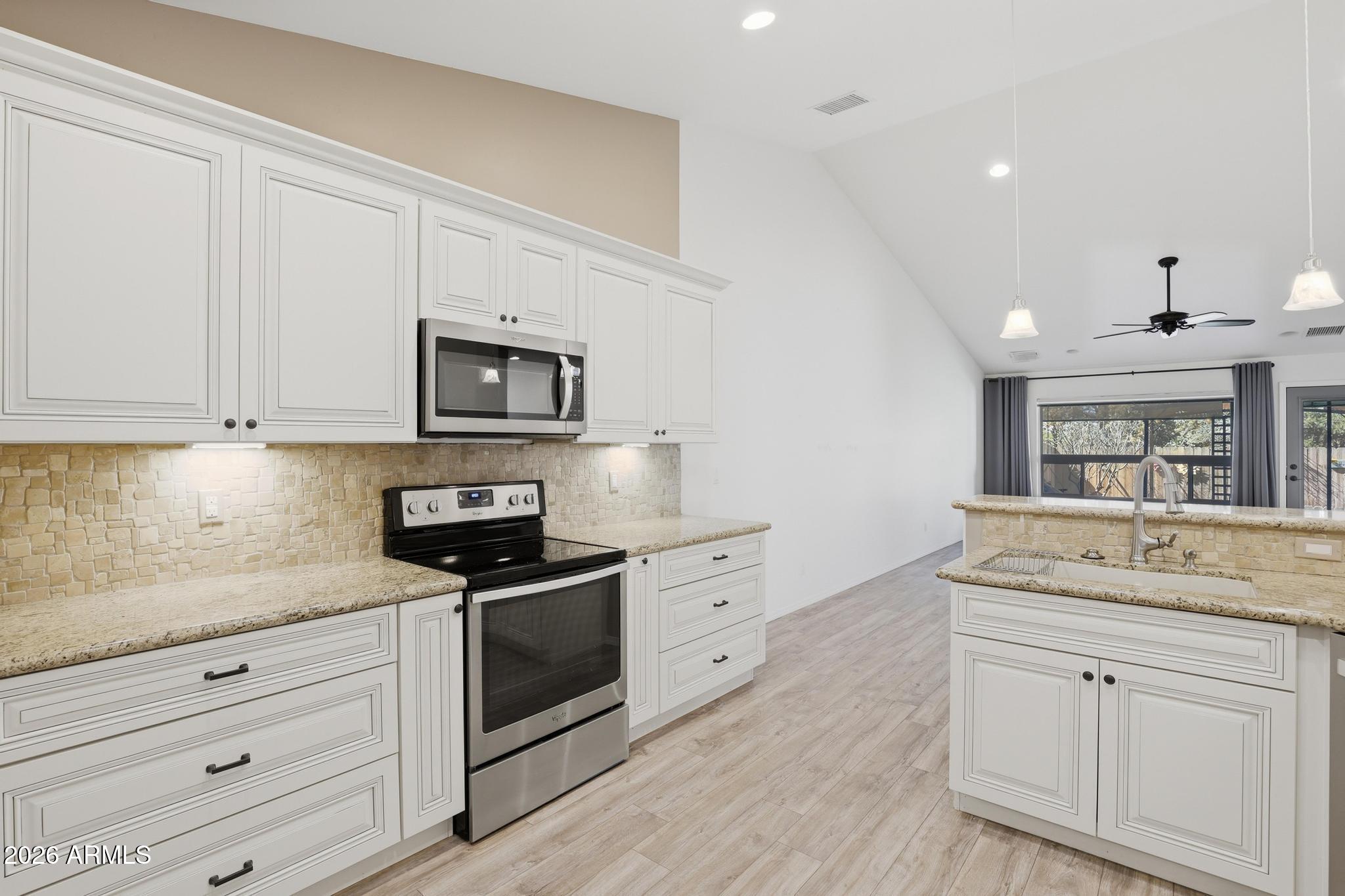 202 North Durango Court Payson, AZ 85541 - Photo 10 of 27 a kitchen with white cabinets stainless steel appliances and sink