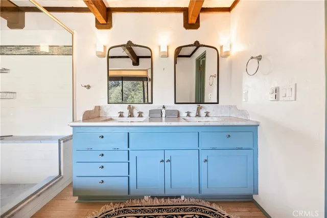 a bathroom with a double vanity sink and a mirror