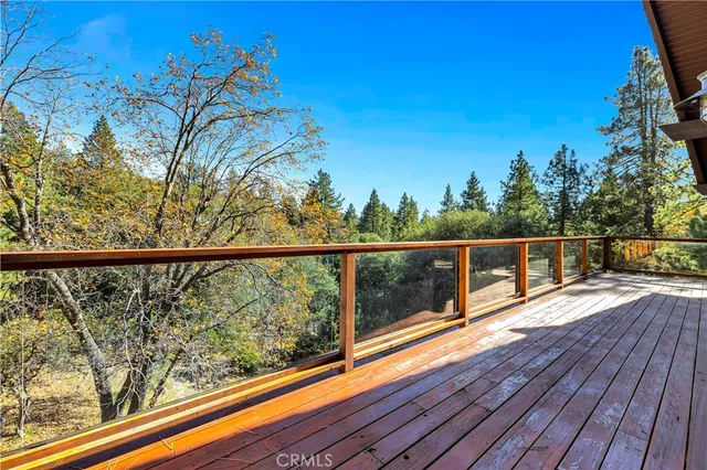 a view of a balcony with wooden floor and fence