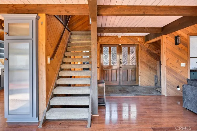 a view of an entryway with wooden floor