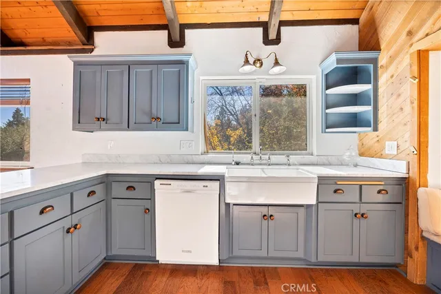 a kitchen with granite countertop white cabinets and white appliances