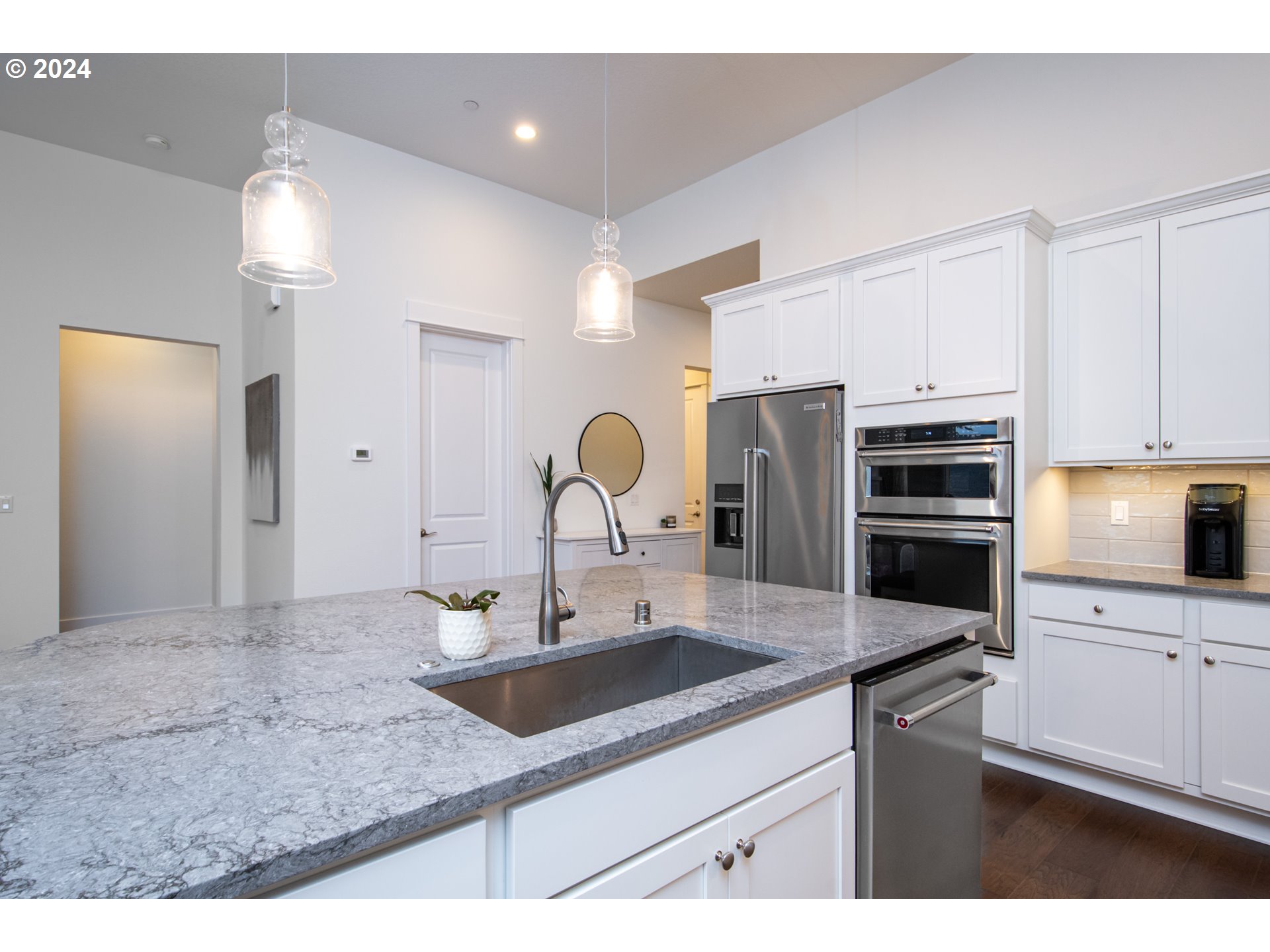 6156 Northwest Olympic Street Camas, WA 98607 - Photo 11 of 29 a kitchen with stainless steel appliances granite countertop a sink and refrigerator