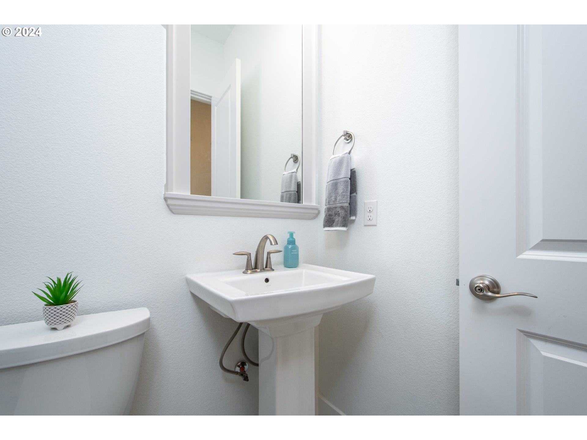 6156 Northwest Olympic Street Camas, WA 98607 - Photo 16 of 29 a bathroom with a sink a mirror and a toilet