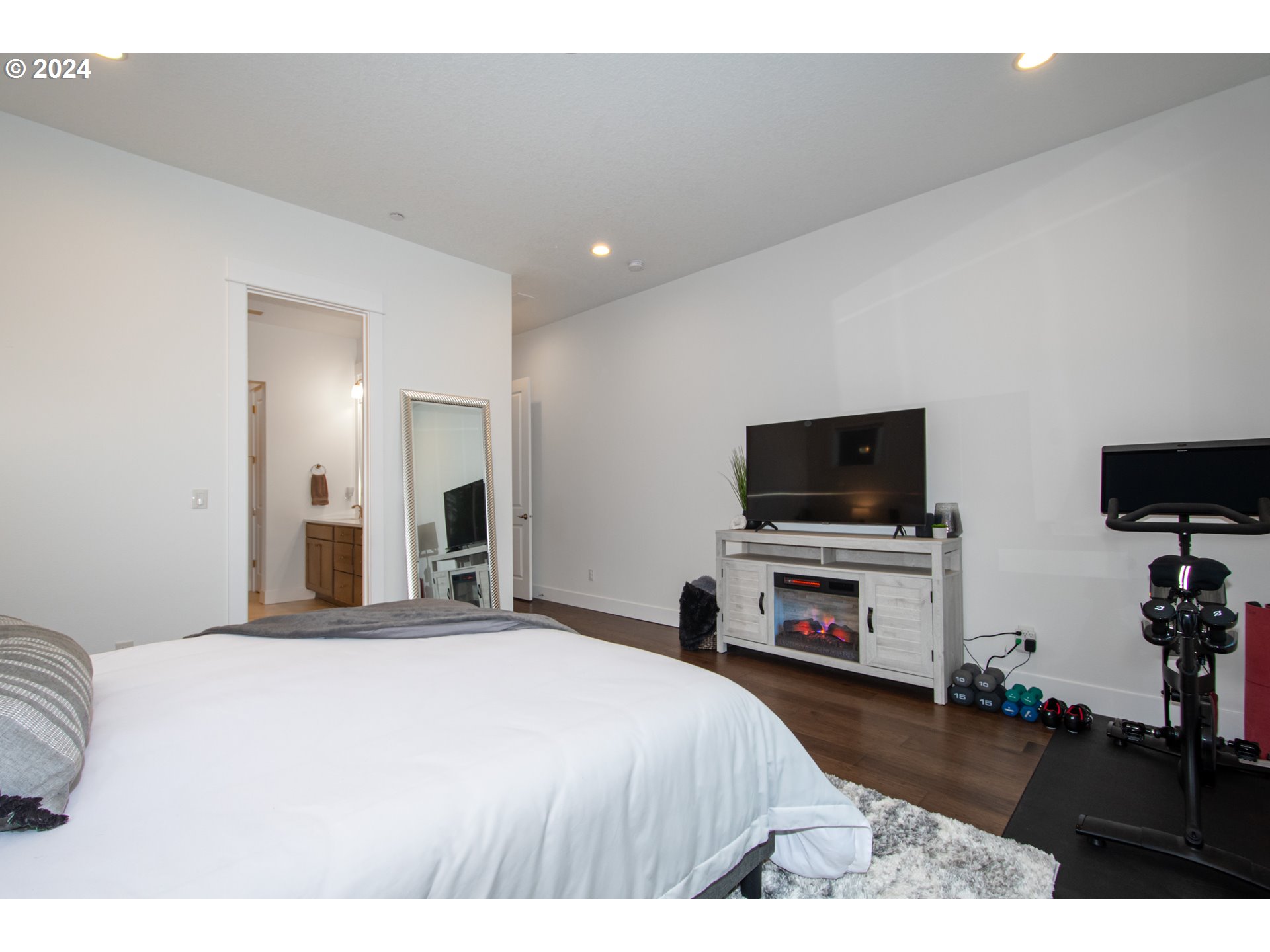 6156 Northwest Olympic Street Camas, WA 98607 - Photo 18 of 29 a bedroom with a bed and a flat screen tv