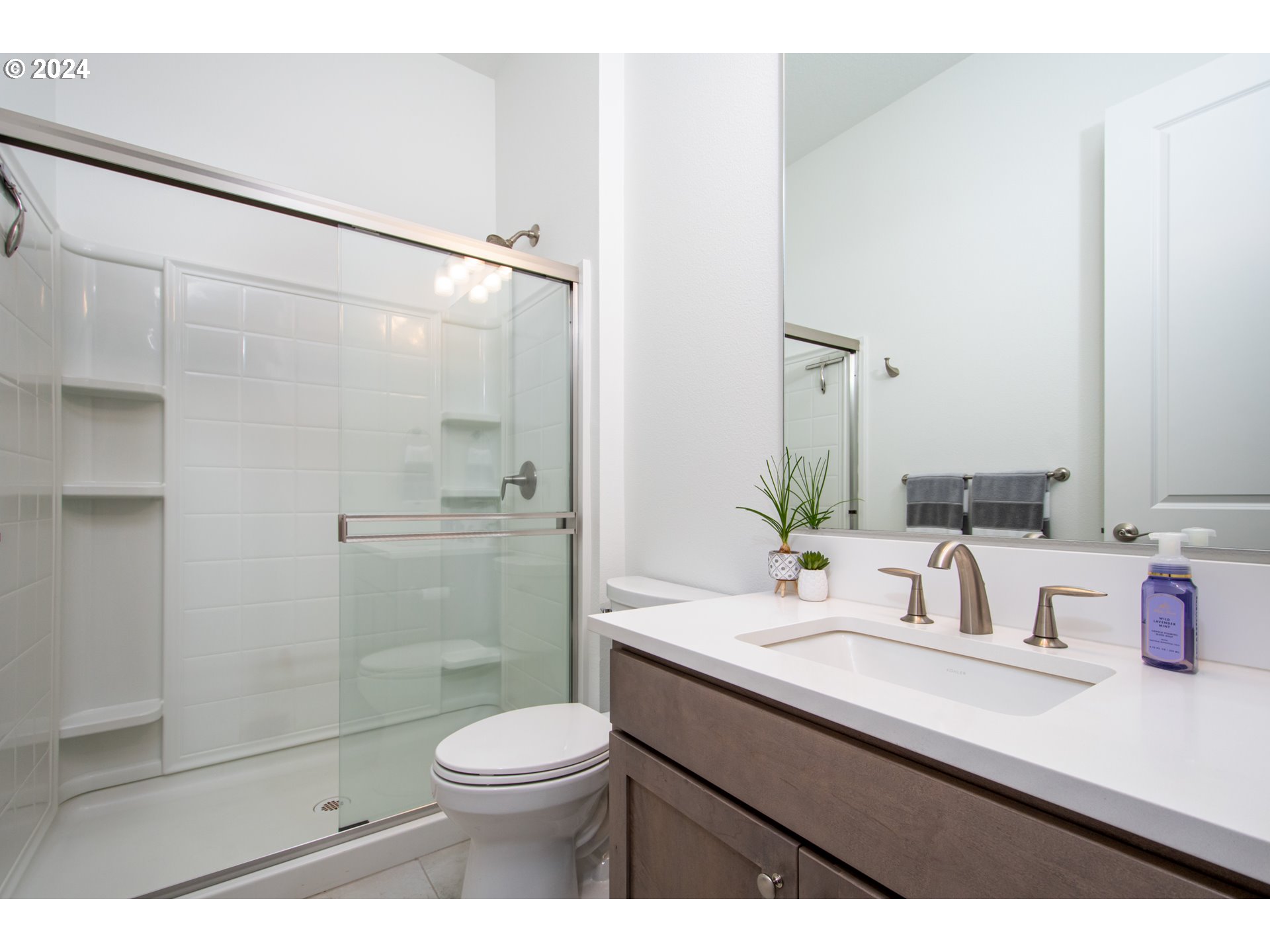 6156 Northwest Olympic Street Camas, WA 98607 - Photo 24 of 29 a bathroom with a sink a toilet and shower