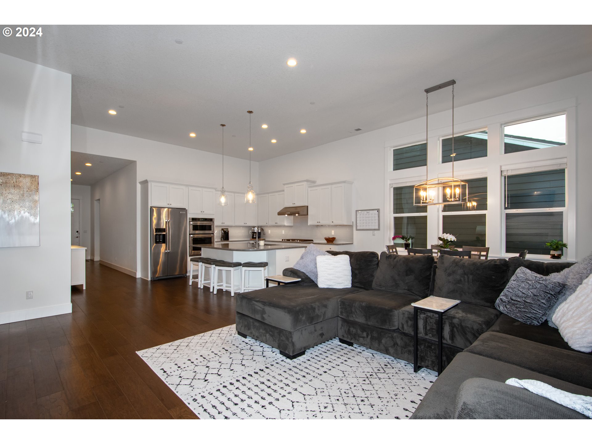 6156 Northwest Olympic Street Camas, WA 98607 - Photo 7 of 29 a living room with furniture kitchen view and a wooden floor