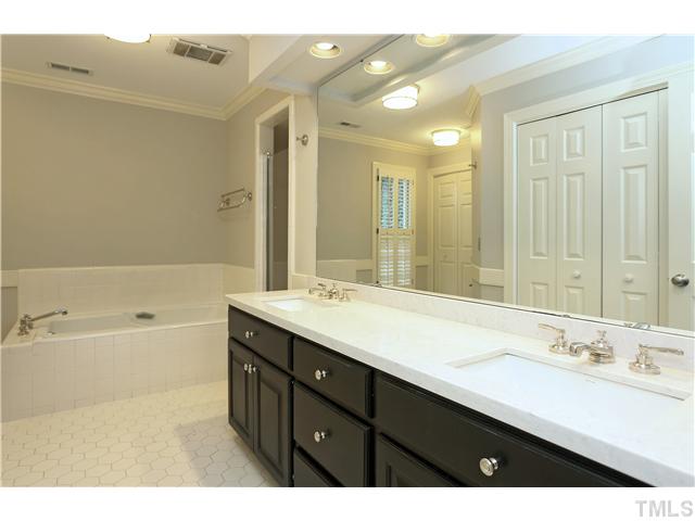 3312 Churchill Road Raleigh, NC 27607 - Photo 11 of 25 a bathroom with a tub a sink double vanity and a mirror