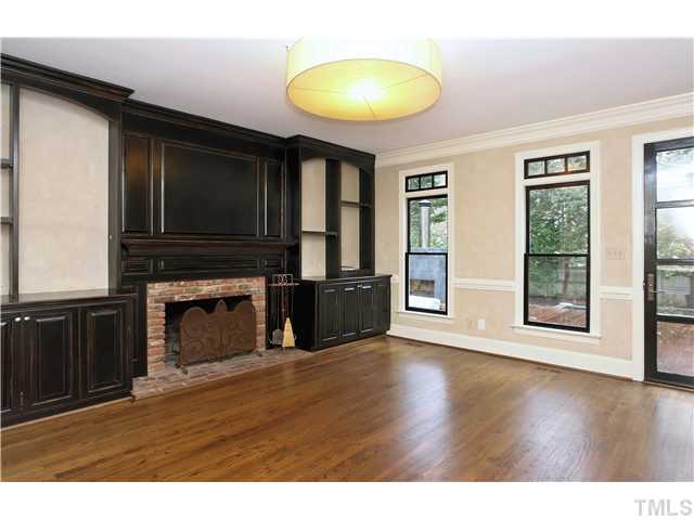 3312 Churchill Road Raleigh, NC 27607 - Photo 4 of 25 a view of empty room with wooden floor and fireplace