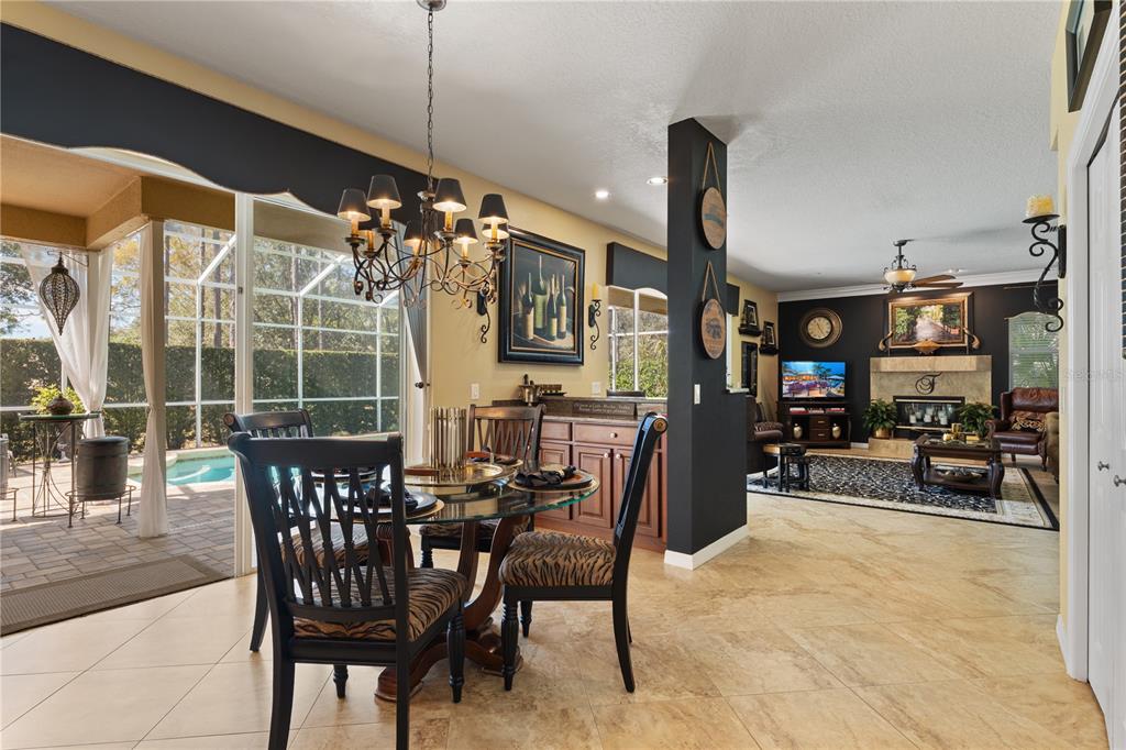 4202 Rotherham Court Palm Harbor, FL 34685 - Photo 16 of 61 a view of a dining room with furniture and a chandelier