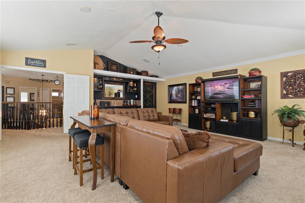 4202 Rotherham Court Palm Harbor, FL 34685 - Photo 29 of 61 a living room with furniture and a flat screen tv