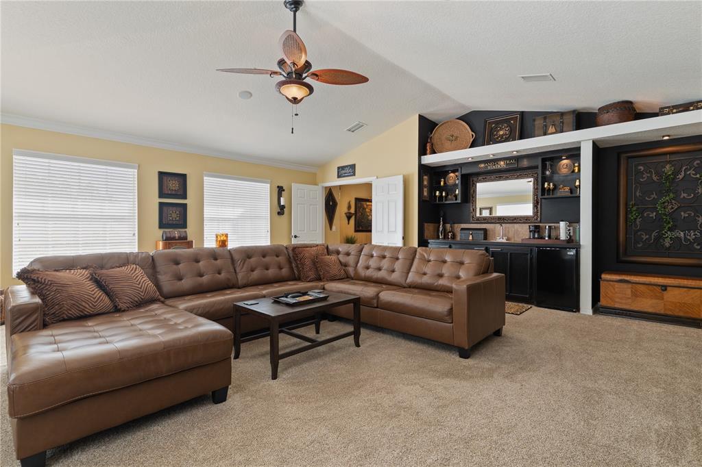 4202 Rotherham Court Palm Harbor, FL 34685 - Photo 30 of 61 a living room with furniture kitchen view and a chandelier