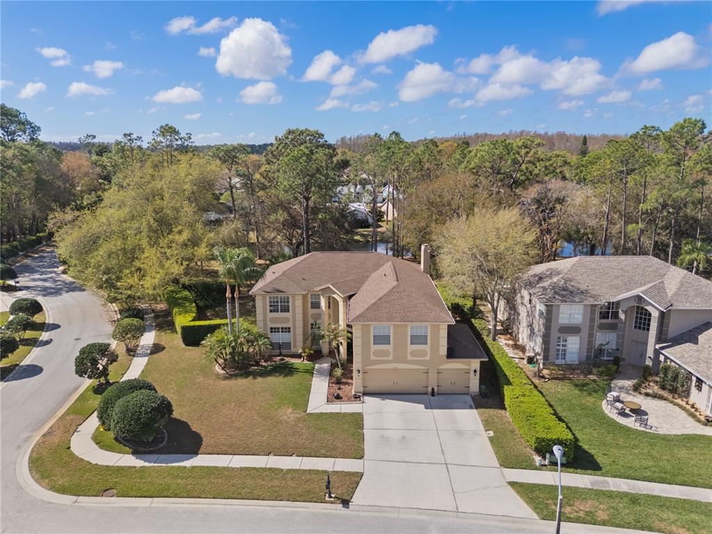 4202 Rotherham Court Palm Harbor, FL 34685 - Photo 5 of 61 a view of a house with a yard and balcony