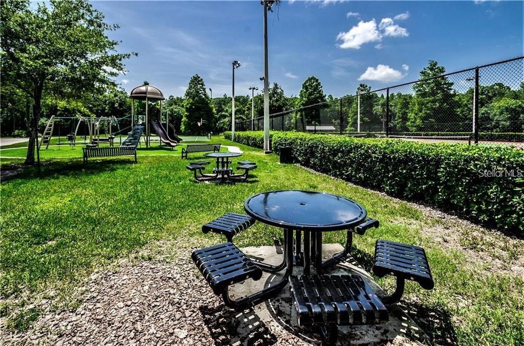4202 Rotherham Court Palm Harbor, FL 34685 - Photo 55 of 61 a view of a backyard with sitting area furniture and fire pit