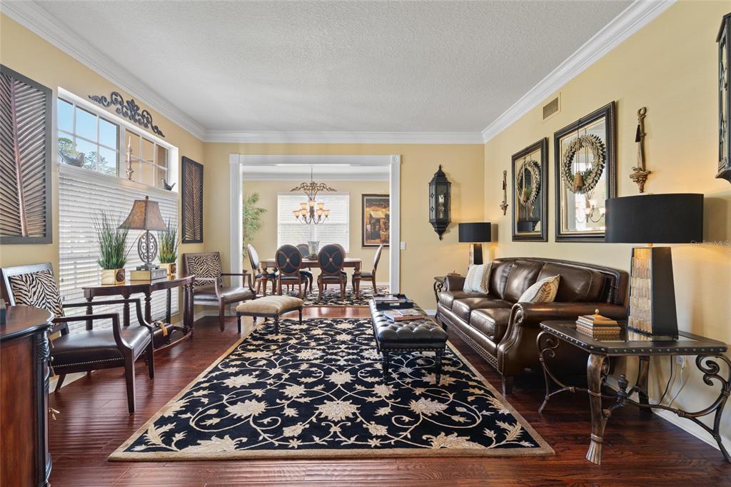 4202 Rotherham Court Palm Harbor, FL 34685 - Photo 7 of 61 a living room with furniture or couch and a wooden floor