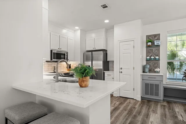 a view of kitchen with sink refrigerator and window