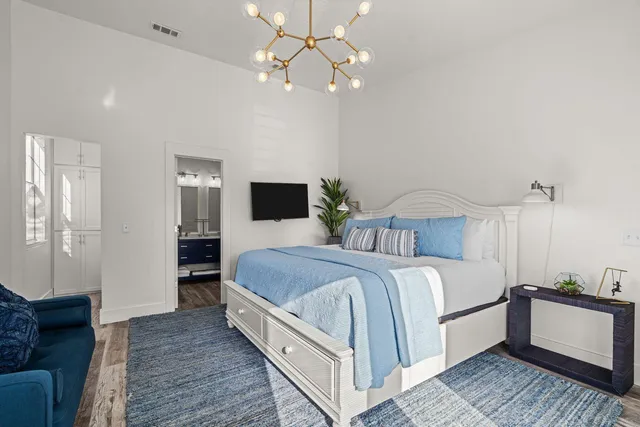 a bedroom with bed and a chandelier