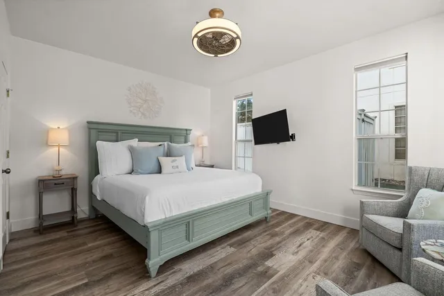 a bedroom with a bed and a flat screen tv