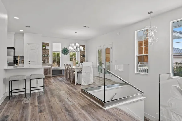 a living room with furniture a wooden floor and a large window