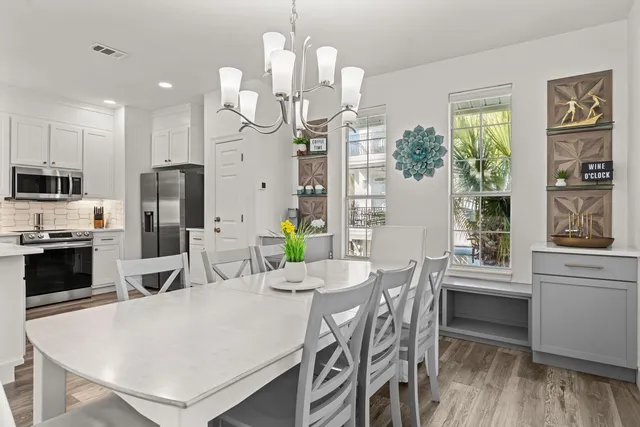 a large kitchen with a table and chairs