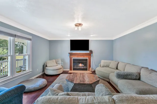 a living room with furniture flat screen tv and a fireplace