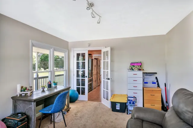 a bedroom with furniture and a window