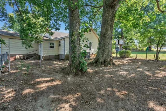 a view of a house with a tree in the background