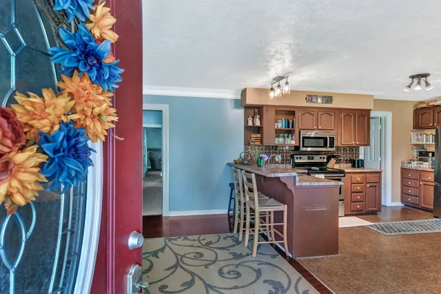a dining room with furniture and wooden floor
